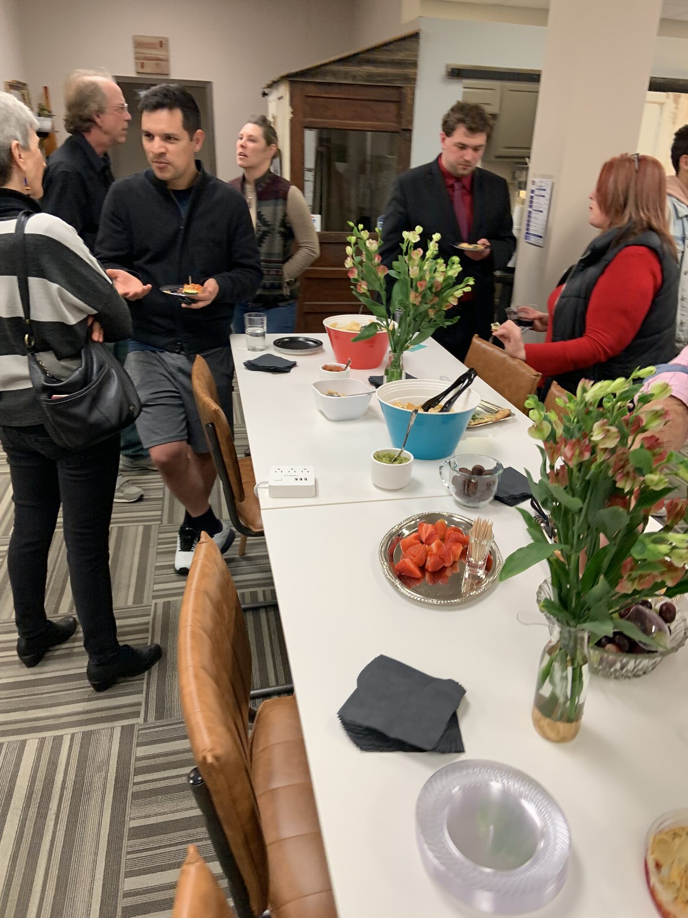 Members sharing food at a community event at Ensemble Coworking