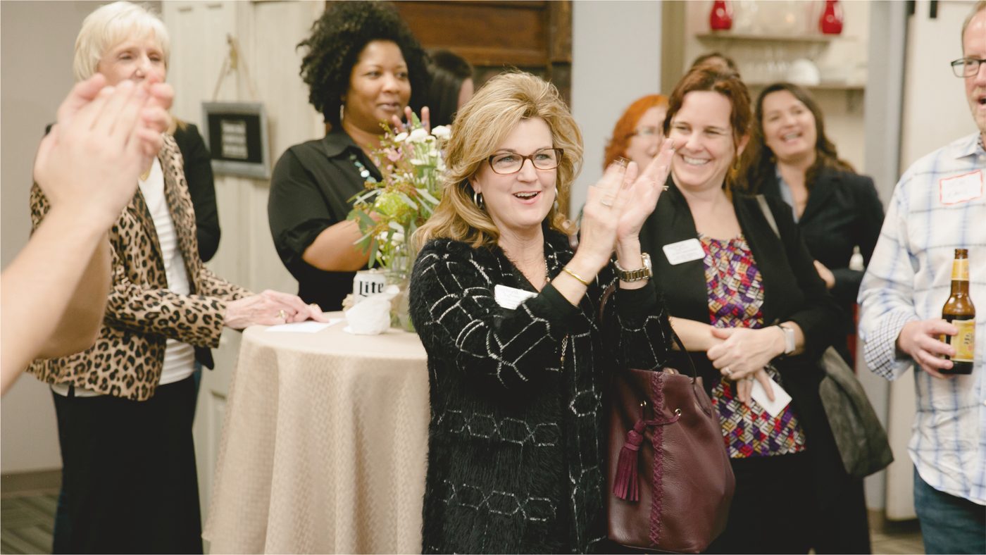Members talking at an evening networking event at Ensemble Coworking