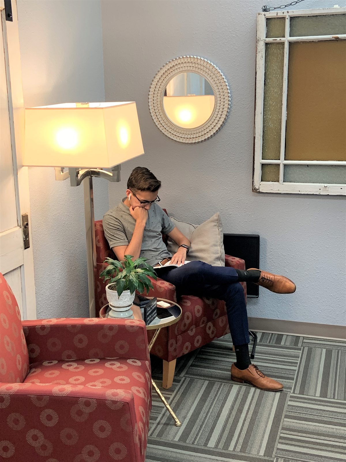 A member working from an armchair in a quiet corner at Ensemble