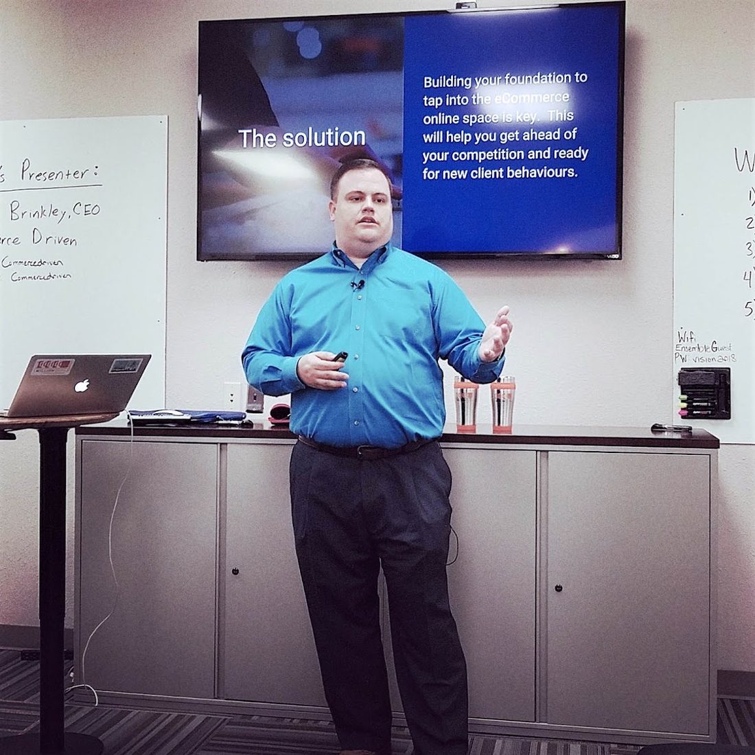 A speaker presenting to members in the Orchestra Room